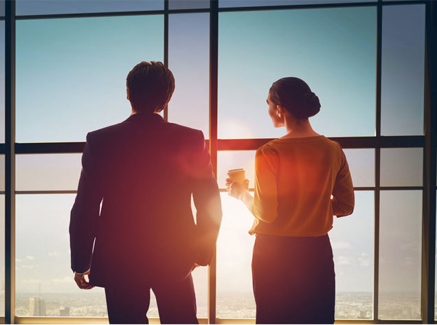 man and women looking out a window
